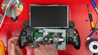 YouTuber makes a 'portable monstrosity' Xbox using a handsaw, hot glue, and eight disk drives: 'It's working. It's actually working!'