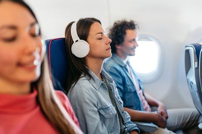 Should passengers remove headphones when flight attendants serve them? Etiquette experts offer the do’s and don’ts