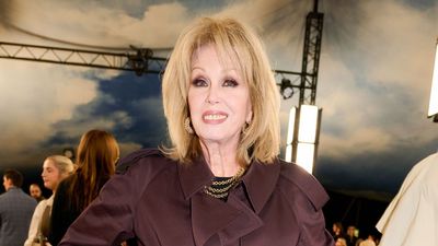 Goodbye camel, hello wine red – Joanna Lumley just confirmed this autumn's palette in a red trench at Burberry show