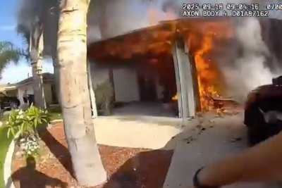 Police officers run into burning home to rescue woman in dramatic bodycam footage