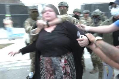 ICE agent appears to put woman in chokehold during protester clashes