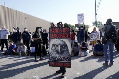 Federal agents fire chemicals as protesters try to block car at immigration site outside Chicago