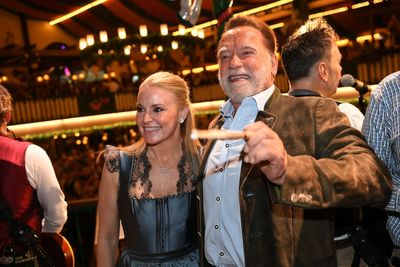 Schwarzenegger directs a band in a beer tent at Munich's Oktoberfest