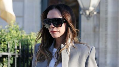 Victoria Beckham perfects power dressing in a grey oversized blazer and flared suit trousers in Paris