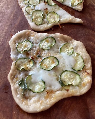 Rachel Roddy’s recipe for pizzette with courgette, mozzarella and mint