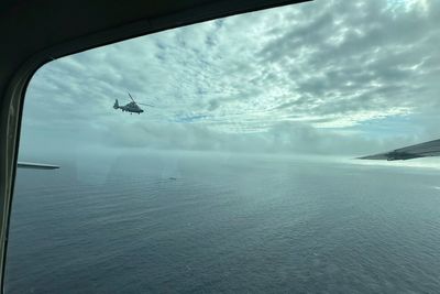 China's coast guard holds National Day celebrations at disputed shoal claimed by Philippines