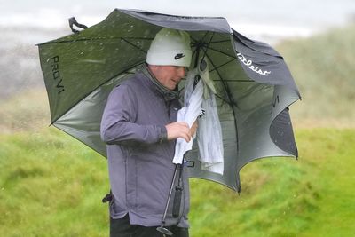 Robert MacIntyre battles brutal conditions to take share of lead on home soil