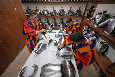 A look at Swiss Guards preparing for a swearing-in ceremony attended by the Pope, in photos