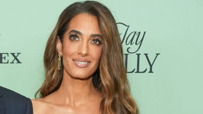 Amal Clooney’s ruby red velvet dress is making me count down the days until party season starts