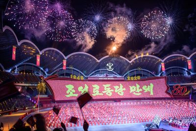 North Korea displays new long-range missile as Kim Jong Un oversees massive military parade