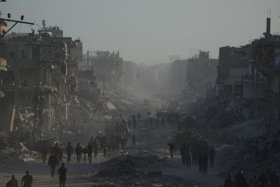 Palestinians return to ruins as aid groups push to scale up deliveries and US troops land in Israel