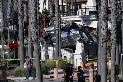 Five hospitalized after helicopter spins out of control and crashes into palm trees in Huntington Beach