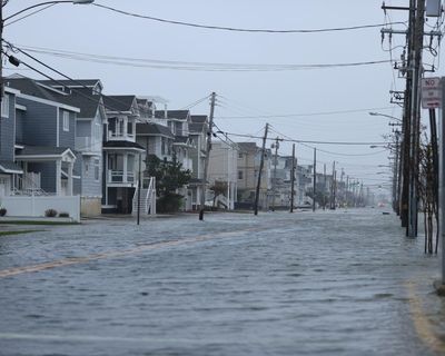 Nor’easter brings flooding to US east coast as storm sweeps away homes in Alaska