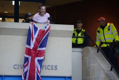 Charges dropped against woman who unfurled Union flag during migrant hotel protest