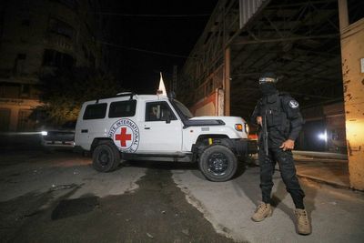 The Latest: Israel says one body handed over wasn't a hostage as aid trucks head for Gaza