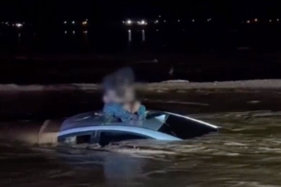 Man and baby rescued from roof of car as sweeping floodwaters surround vehicle in dramatic video