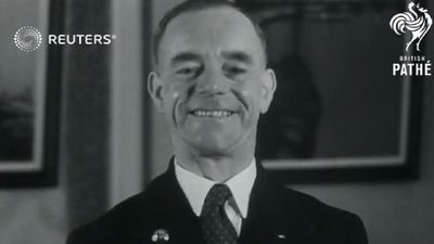 Tower Bridge begins opening with double-decker bus still on it. Then his wartime training kicks in