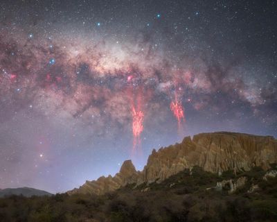 ‘A perfect coincidence’: rare red lightning captured in New Zealand skies