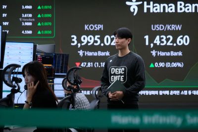 Asian shares are mixed as region watches for outcome from Trump's visits