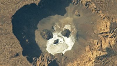 Glowering 'skull' stares upward from a giant volcanic pit in the Sahara — Earth from space