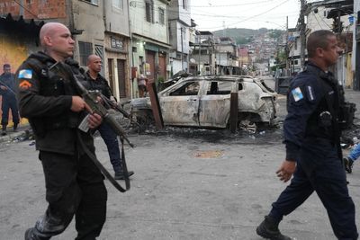 Photos show massive police raid in Rio's favelas leaving dozens dead in clashes with drug gangs