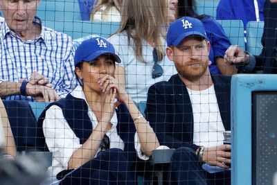 Prince Harry and Meghan Markle sit in front of LA royalty at Game 4 of World Series