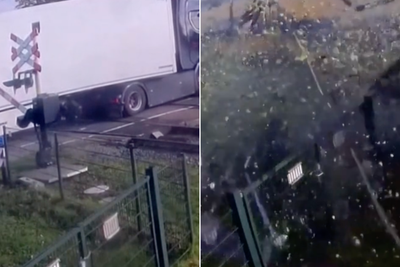 High-speed train smashes through lorry stuck on level crossing, leaving five injured
