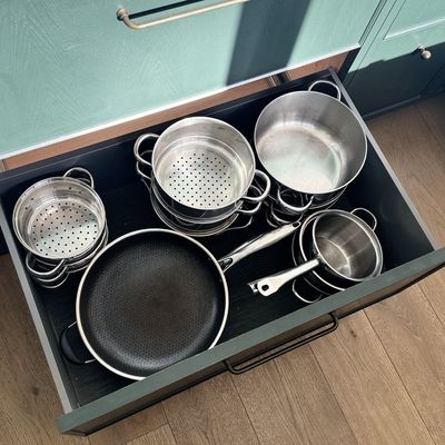 Four kitchens later, I've finally found the perfect kitchen storage hack for pan lids, and it's made dinnertime easier and calmer