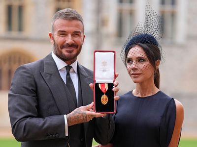 Arise, Sir David Beckham! England legend receives knighthood from the King as proud Victoria watches on