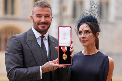 Bend a knee like Beckham: Soccer star is knighted by King Charles III