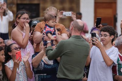 Prince William cuddles baby as he takes selfies with Brazilian crowds