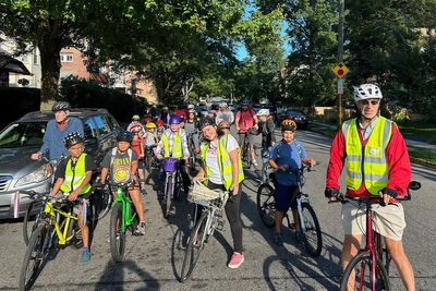 From a few to more than 350, children and parents ride together to school as a 'bike bus'