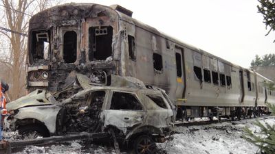 A New York woman got caught behind barrier of level crossing, inexplicably she decided to drive forward onto the tracks the moment a train came