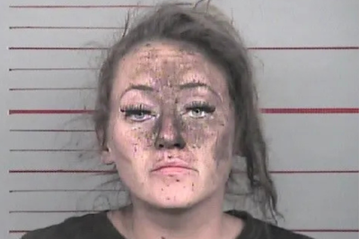 Iowa woman arrested on burglary charge after being found stuck between the walls of a business