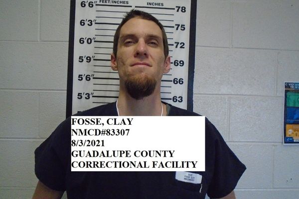 Convict charged in decade-old cold case where victim was found dead and covered with blankets on apartment floor