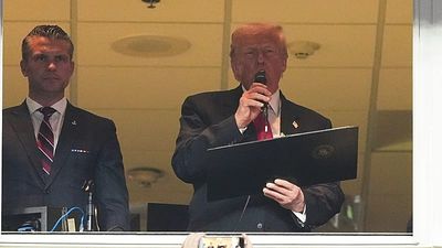 Donald Trump cheered and booed as first sitting US president at regular-season NFL game since 1978
