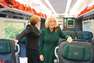 Queen Camilla stuns commuters by riding train for Armistice Day service