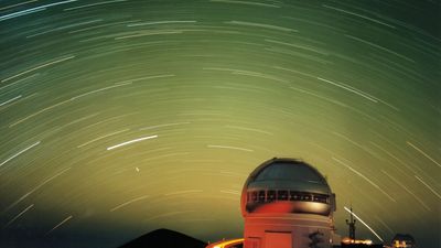 Star and satellite streaks in a green night sky | Space photo of the day for Nov. 12, 2025