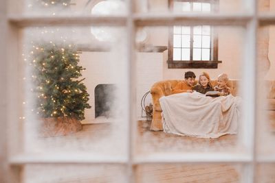 I used a can of cheap spray snow and an old window to take these cozy Christmas photos