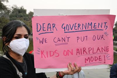 Angry protesters wearing masks and carrying oxygen cylinders demand answers over ‘toxic’ Delhi air