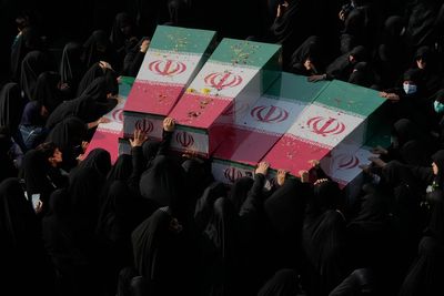 Photos show mourners in Tehran honoring the unknown soldiers killed in the 1980's Iran-Iraq war