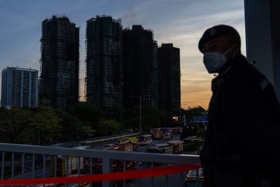 Hong Kong firefighters make final search for survivors after apartment tower blaze kills 94