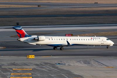 Delta plane slides off icy runway shutting major airport over Thanksgiving weekend