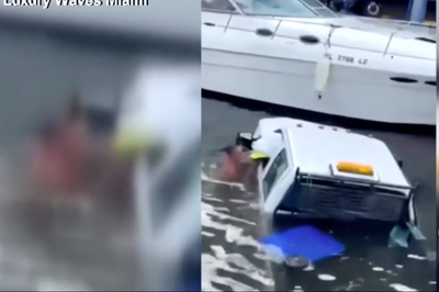 Dramatic footage captures the moment hero passersby jump in Miami River and rescue two people trapped in sinking truck