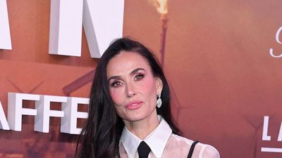 Demi Moore's layered sheer blouse and strappy black dress combination is a genius styling trick for party season