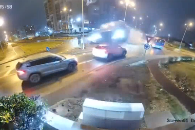 Moment out of control Mercedes flies over cars on busy road after hitting roundabout