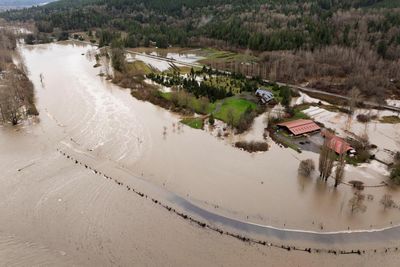 Powerful storms dump heavy rain and swell rivers across US Pacific north-west