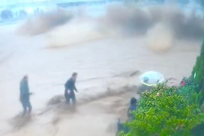 Children rescued seconds before school wall collapses on top of them as flash floods slam Iraq