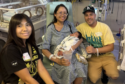 A surprise baby was found growing behind a woman’s 22-pound cyst. The child was successfully delivered