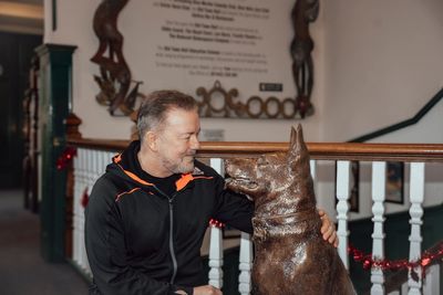 Comedian Ricky Gervais unveils statue paying tribute to dog from After Life